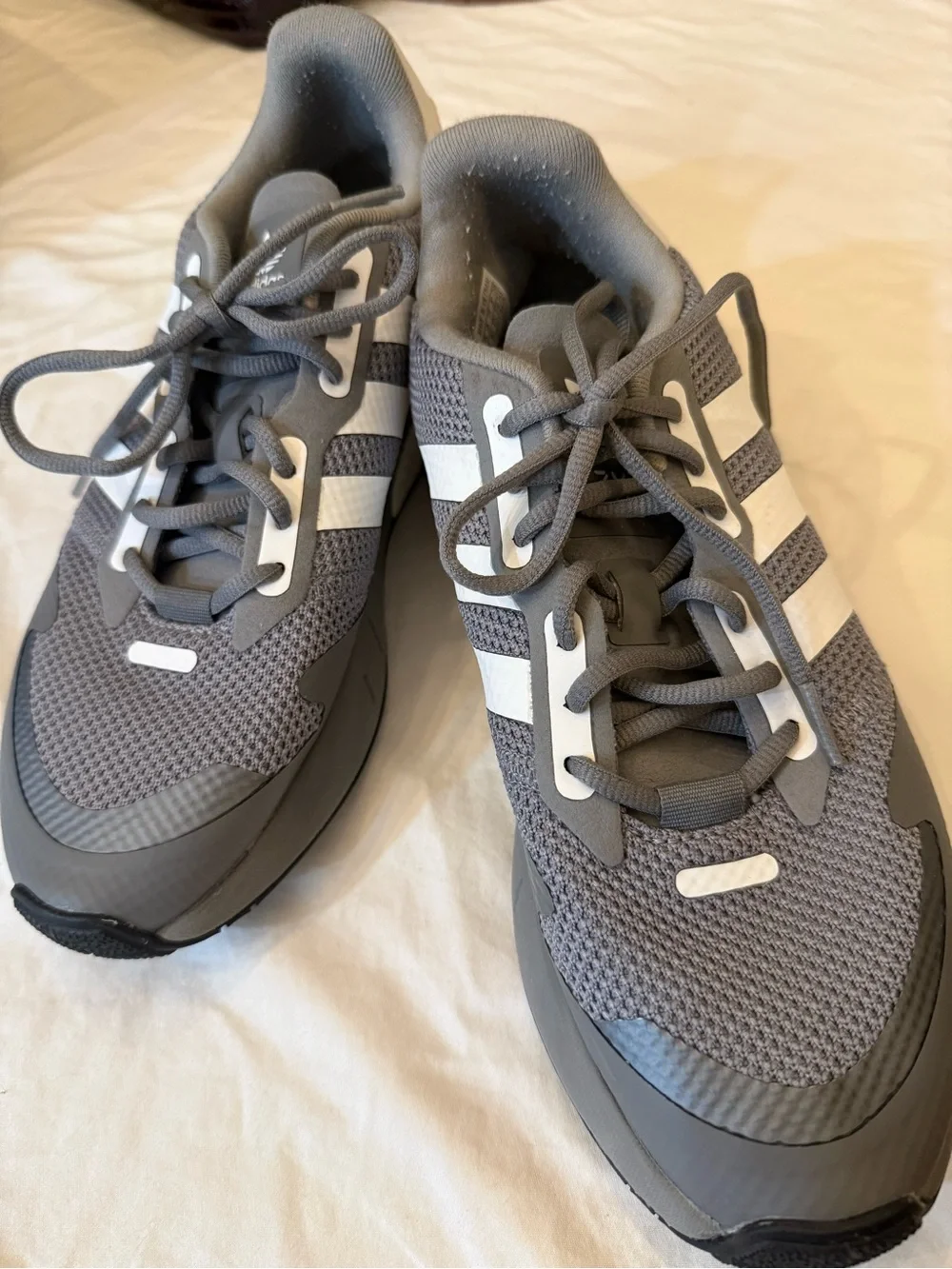adidas gray and cream athletic shoe.
